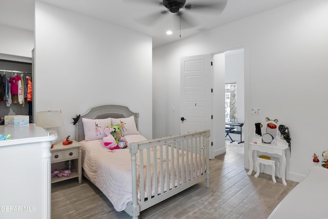 bedroom with ceiling fan, hardwood / wood-style flooring, and a closet