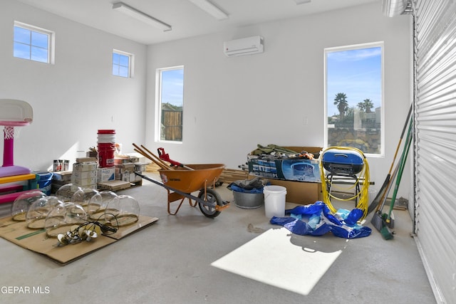 misc room with a wall mounted AC and concrete flooring