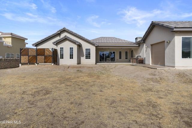 rear view of house featuring a garage