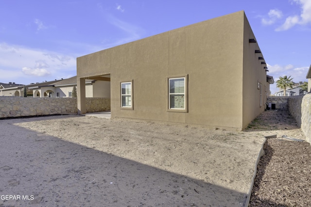 rear view of house featuring central AC unit