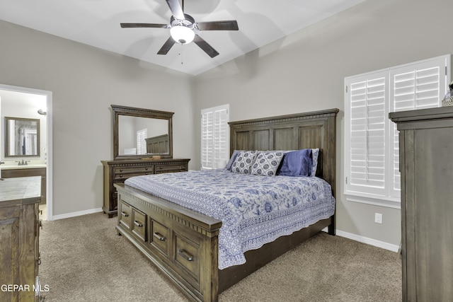 bedroom featuring ceiling fan, light colored carpet, and ensuite bathroom