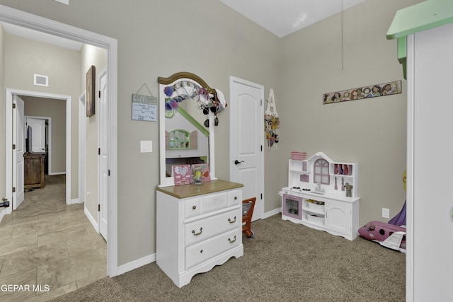 recreation room featuring light colored carpet