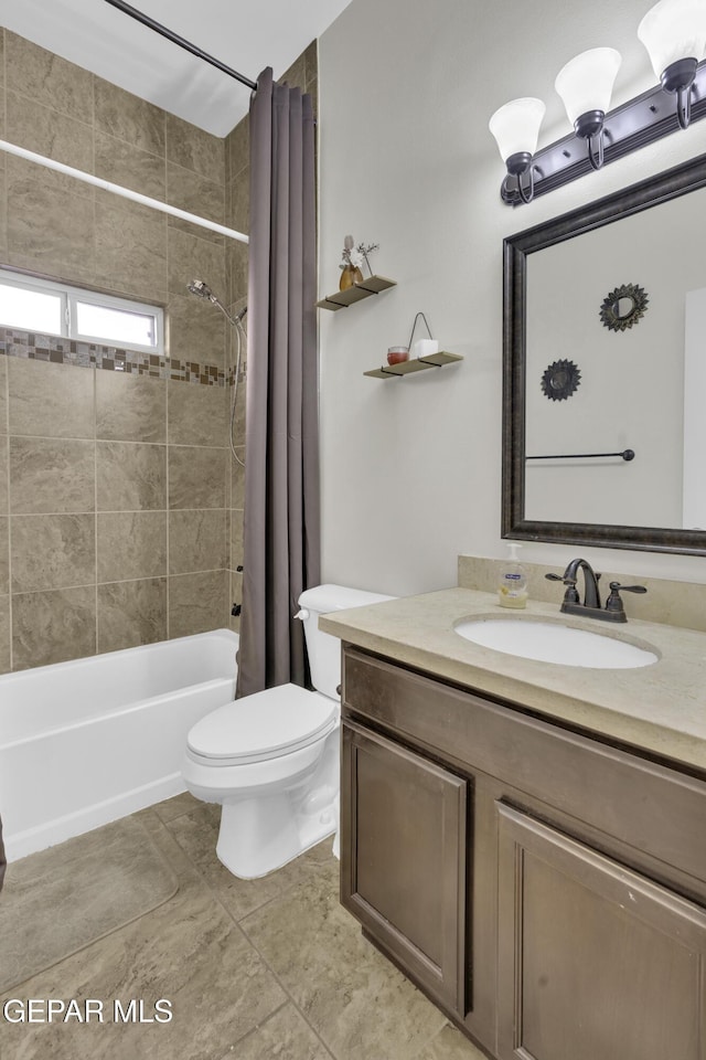 full bathroom featuring tile patterned flooring, toilet, vanity, and shower / tub combo with curtain