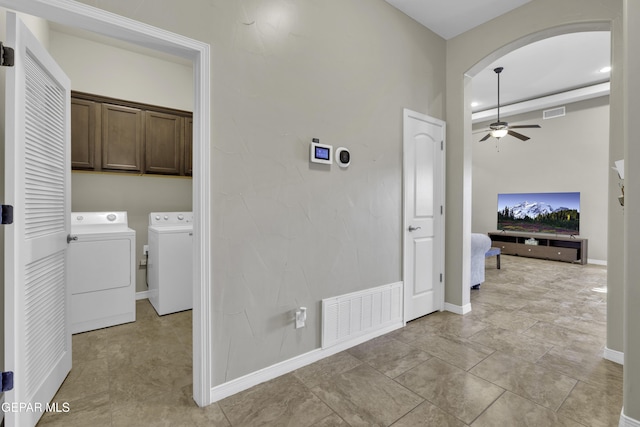 washroom with ceiling fan, cabinets, and washer and clothes dryer