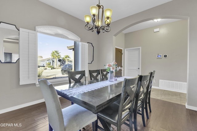 dining room featuring a notable chandelier and dark hardwood / wood-style flooring