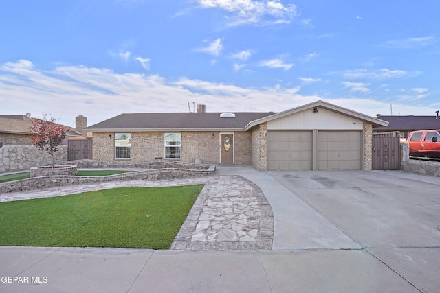 ranch-style home with a garage and a front lawn