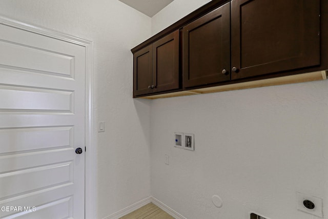 laundry area featuring washer hookup, cabinets, gas dryer hookup, and hookup for an electric dryer