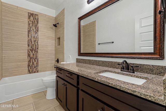 full bathroom with vanity, toilet, and tiled shower / bath combo