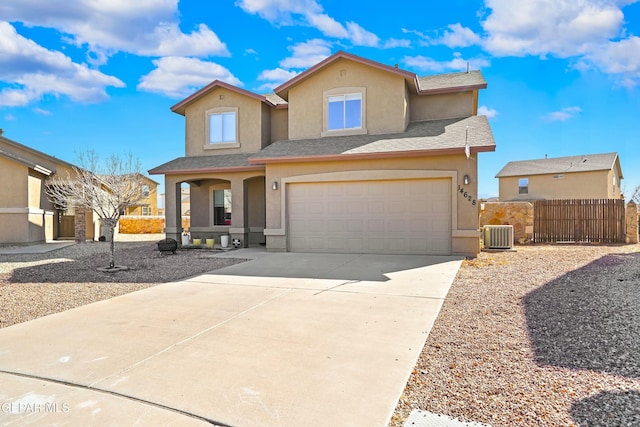 view of front of property with central air condition unit and a garage