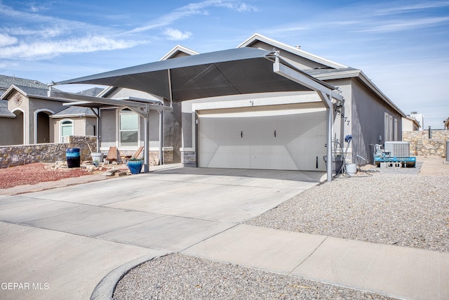 view of front of house featuring a garage and central air condition unit