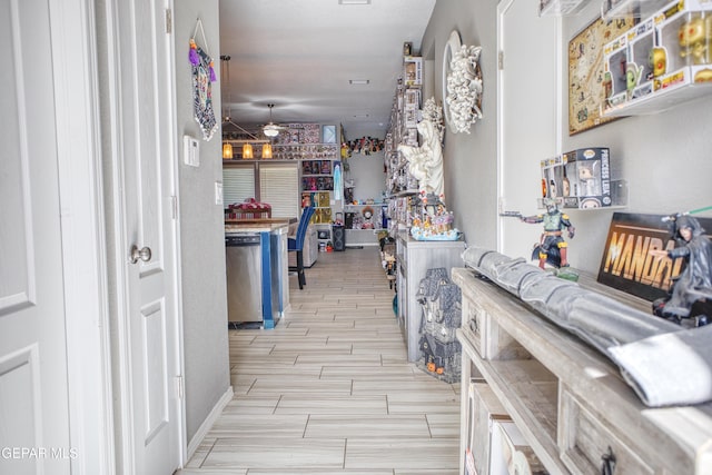 interior space featuring ceiling fan and stainless steel dishwasher