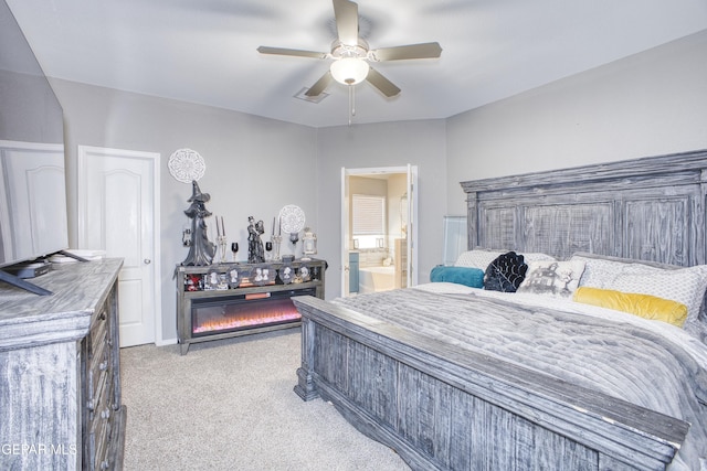 bedroom with light carpet, connected bathroom, and ceiling fan