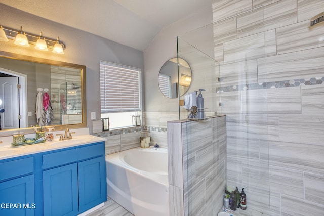 bathroom with vanity, separate shower and tub, and lofted ceiling