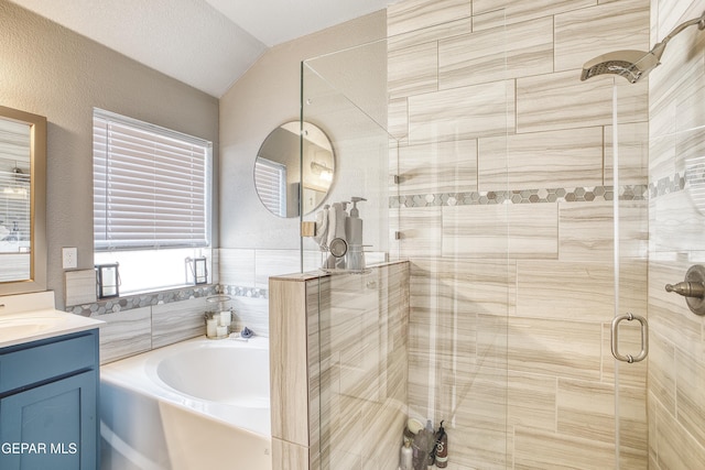 bathroom with lofted ceiling, separate shower and tub, and vanity