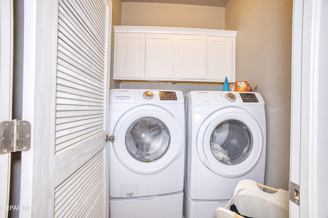 laundry area featuring cabinets and separate washer and dryer