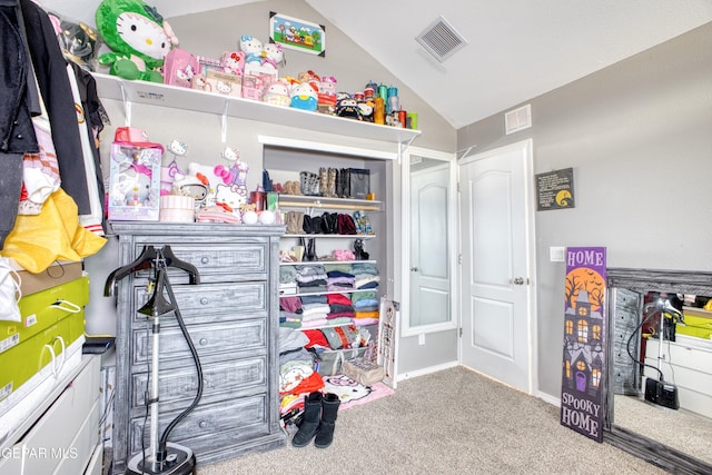 walk in closet featuring light colored carpet and lofted ceiling