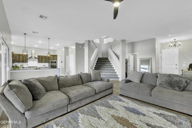 living room featuring ceiling fan and hardwood / wood-style flooring