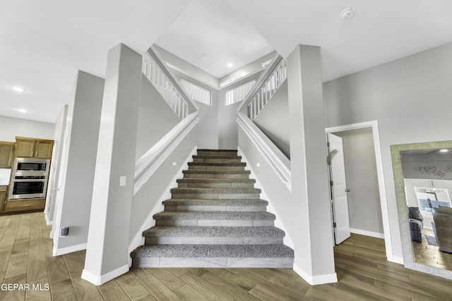 stairs featuring a high ceiling