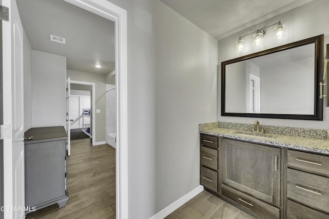 bathroom featuring hardwood / wood-style floors and vanity