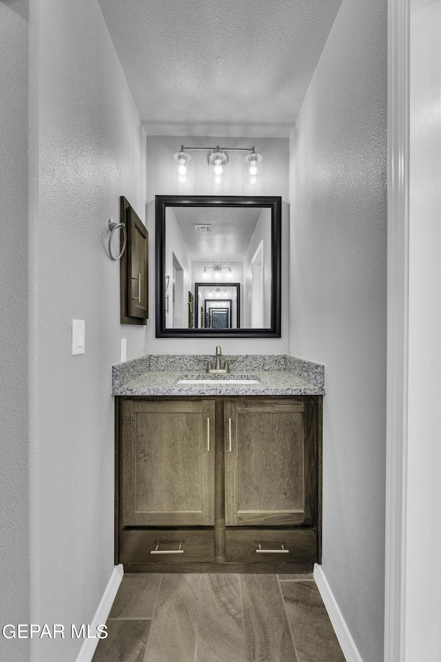 bathroom featuring vanity and a textured ceiling