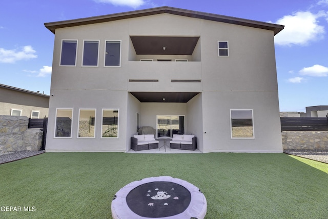 back of property featuring an outdoor living space, a lawn, and a patio