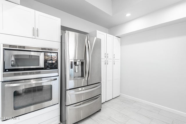 kitchen featuring white cabinets and appliances with stainless steel finishes