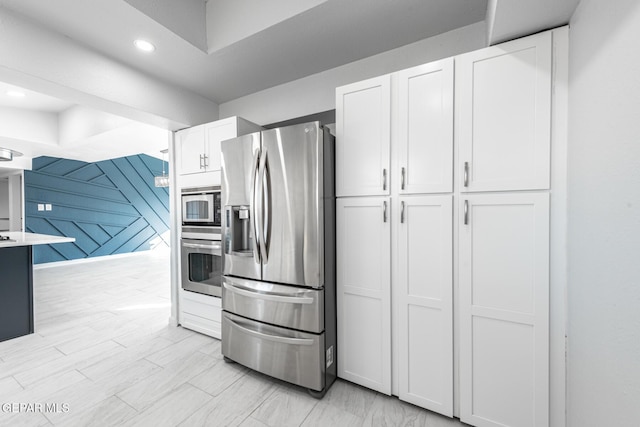 kitchen featuring white cabinetry and appliances with stainless steel finishes