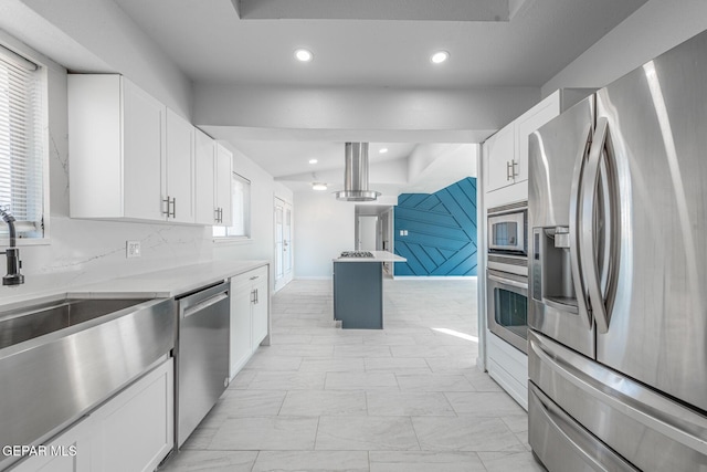 kitchen with decorative backsplash, white cabinets, sink, pendant lighting, and stainless steel appliances