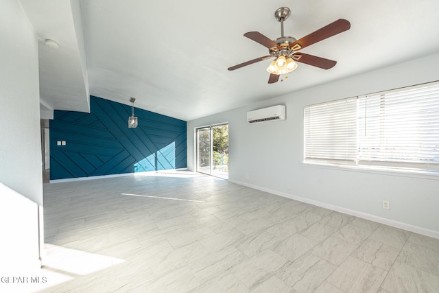 unfurnished room with a wall unit AC and ceiling fan