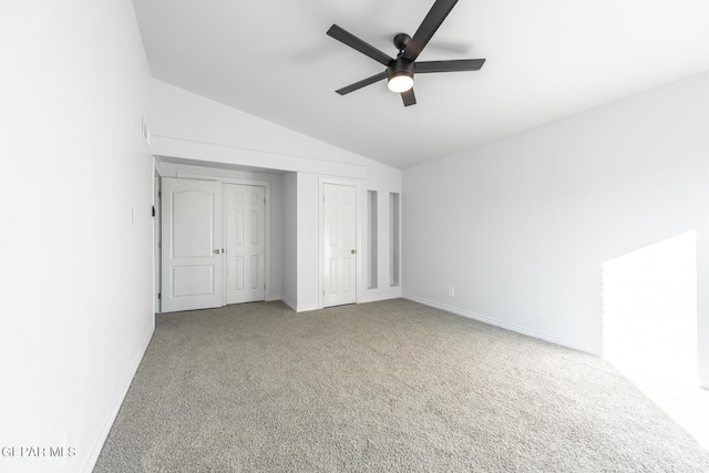 unfurnished bedroom featuring ceiling fan, carpet flooring, and lofted ceiling