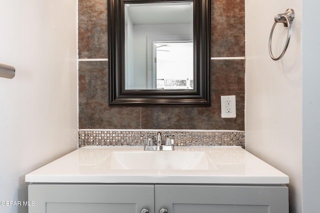 bathroom featuring decorative backsplash and vanity