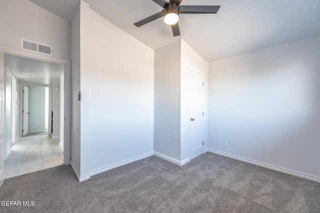 unfurnished room with ceiling fan, carpet flooring, and lofted ceiling