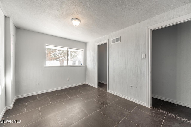 unfurnished bedroom featuring a closet and a textured ceiling