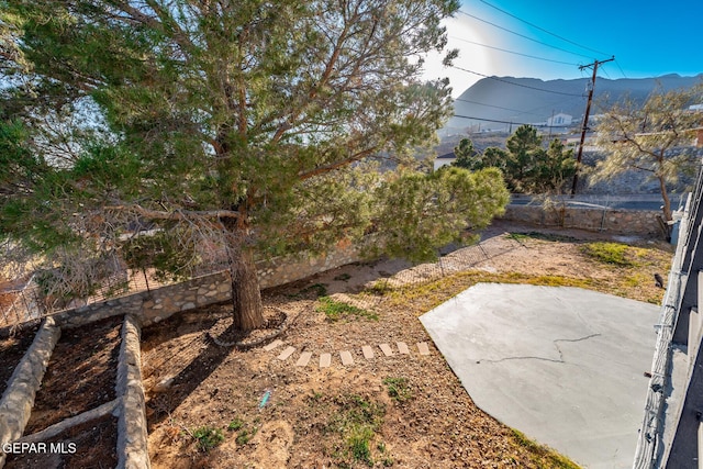 view of yard featuring a mountain view and a patio area