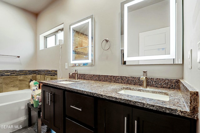 bathroom featuring a tub to relax in and vanity