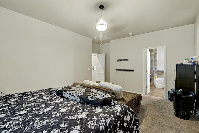 carpeted bedroom with ceiling fan and ensuite bath