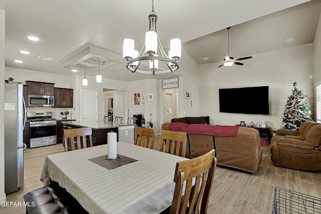 dining space featuring ceiling fan with notable chandelier