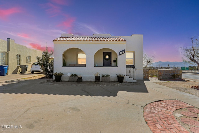 mediterranean / spanish-style house featuring a mountain view and solar panels