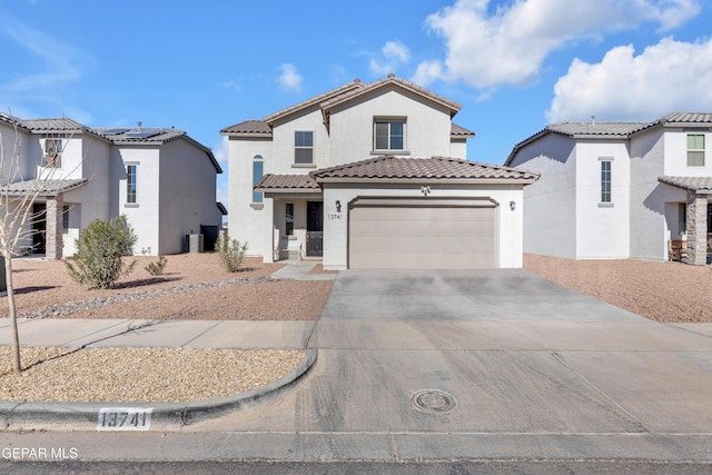 mediterranean / spanish house with a garage