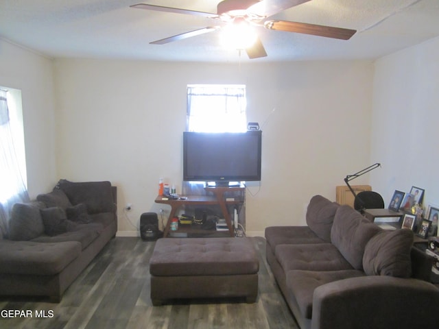 living room with dark wood-type flooring and ceiling fan