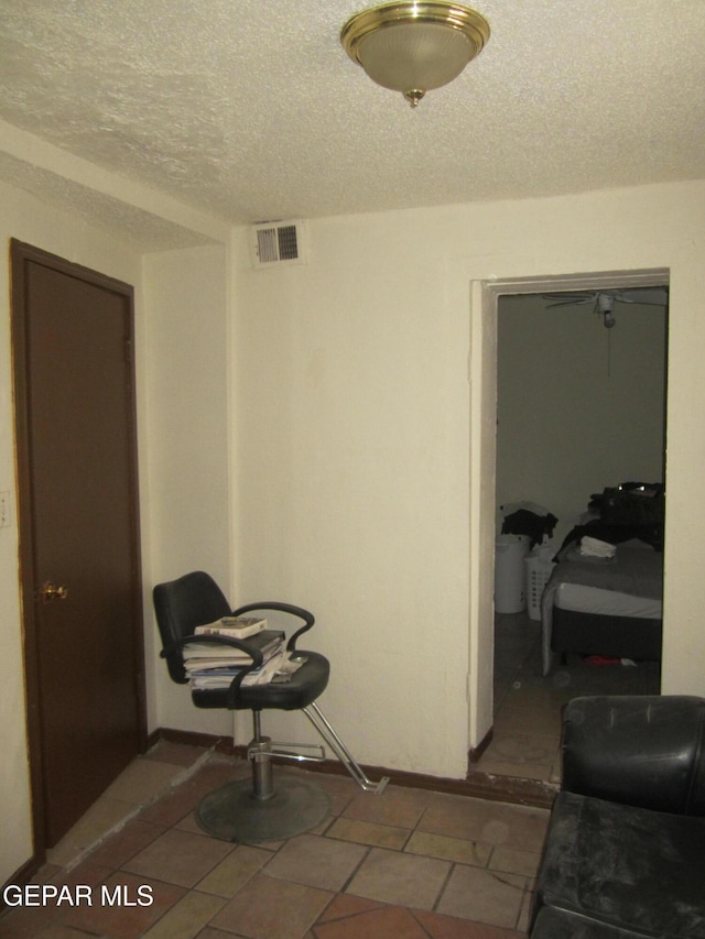 living area with a textured ceiling