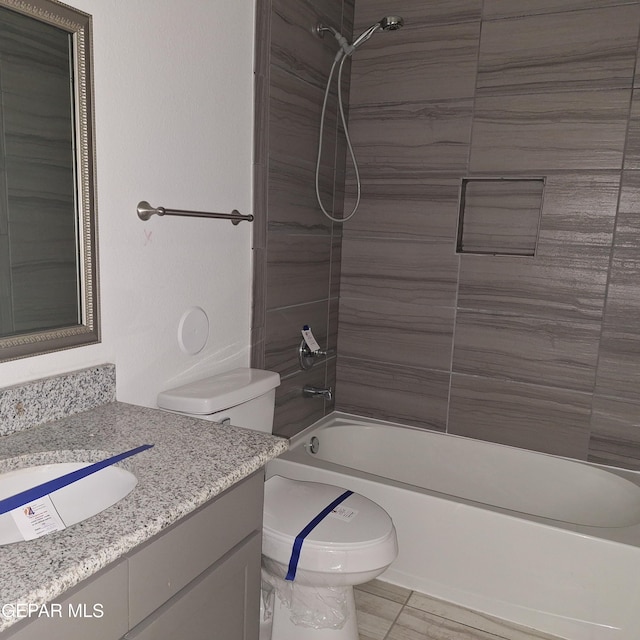 full bathroom with tiled shower / bath combo, toilet, and vanity