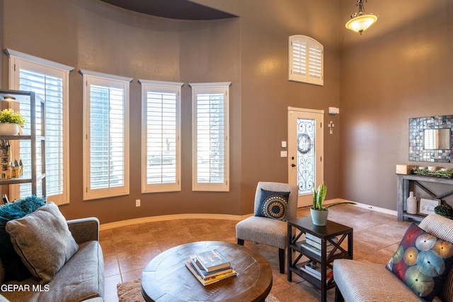 tiled living room with a high ceiling