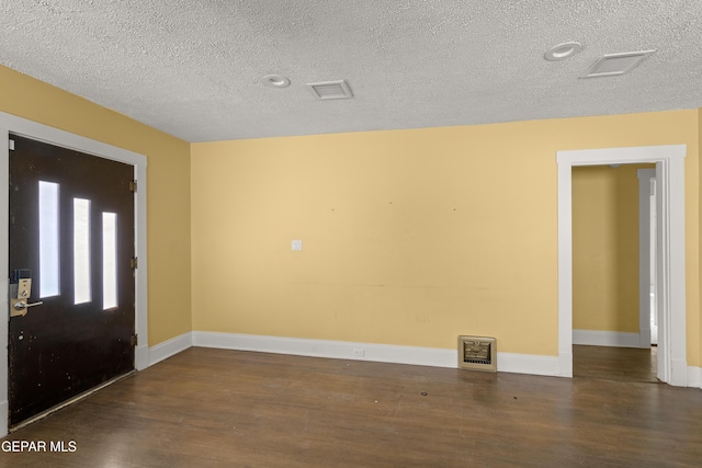 entrance foyer with dark hardwood / wood-style floors and a textured ceiling