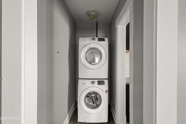 laundry room with stacked washer / dryer