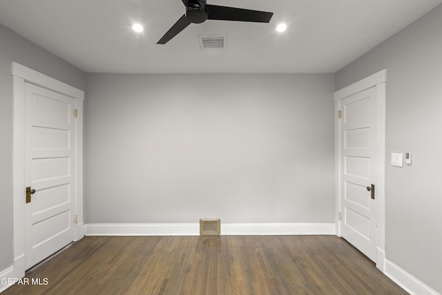 unfurnished room featuring dark wood-type flooring and ceiling fan