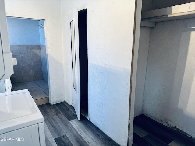 bathroom with washer / clothes dryer and hardwood / wood-style floors