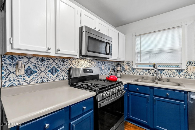 kitchen featuring sink, white cabinets, appliances with stainless steel finishes, and blue cabinets