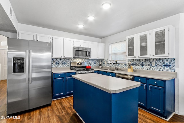 kitchen featuring sink, blue cabinetry, white cabinetry, a kitchen island, and stainless steel appliances