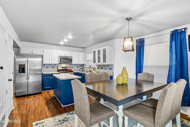 dining area with sink and dark wood-type flooring